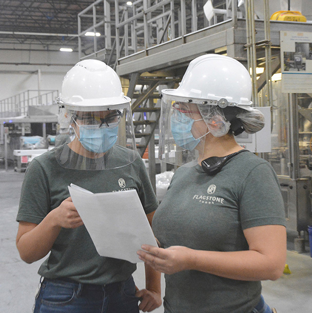 Two employees from Flagstone El Paso reviewing paperwork