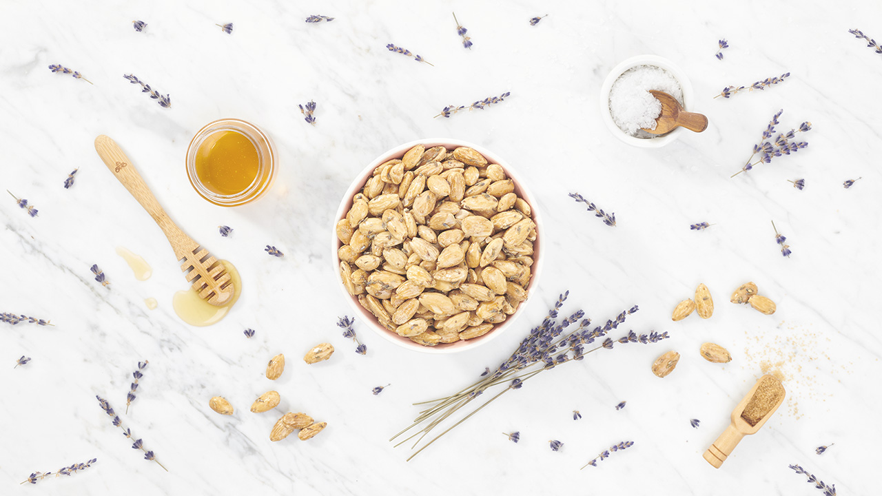 lavender honey almonds on a marble table with scattered ingredients